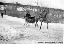 Washington Street train bridge with horse drawn sleigh in foreground